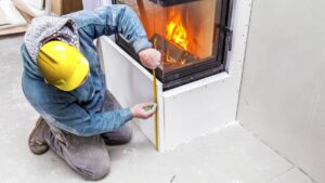 Man-Installing-Fire-Resistant-Materials-on-Fireplace