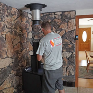 Man Professionally Installing a Wood Stove