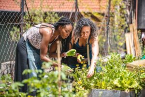 Benefits of Gardening Women in Garden Tending to Plants