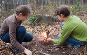 Essential Skills for Homesteading Kids starting a fire