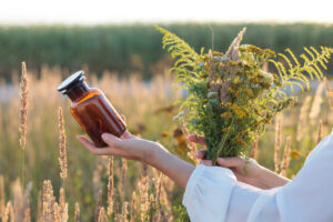 The Benefits of Natural Remedies Woman Holding Jar and Plants