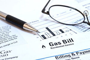 Lower Your Bills Gas Bill with pen and glasses